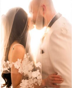 Bride and groom backlit by sun.