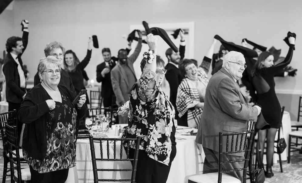 Guests wave napkins in celebration.