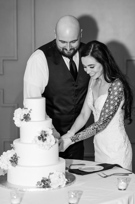 Bride and groom cut the wedding cake.