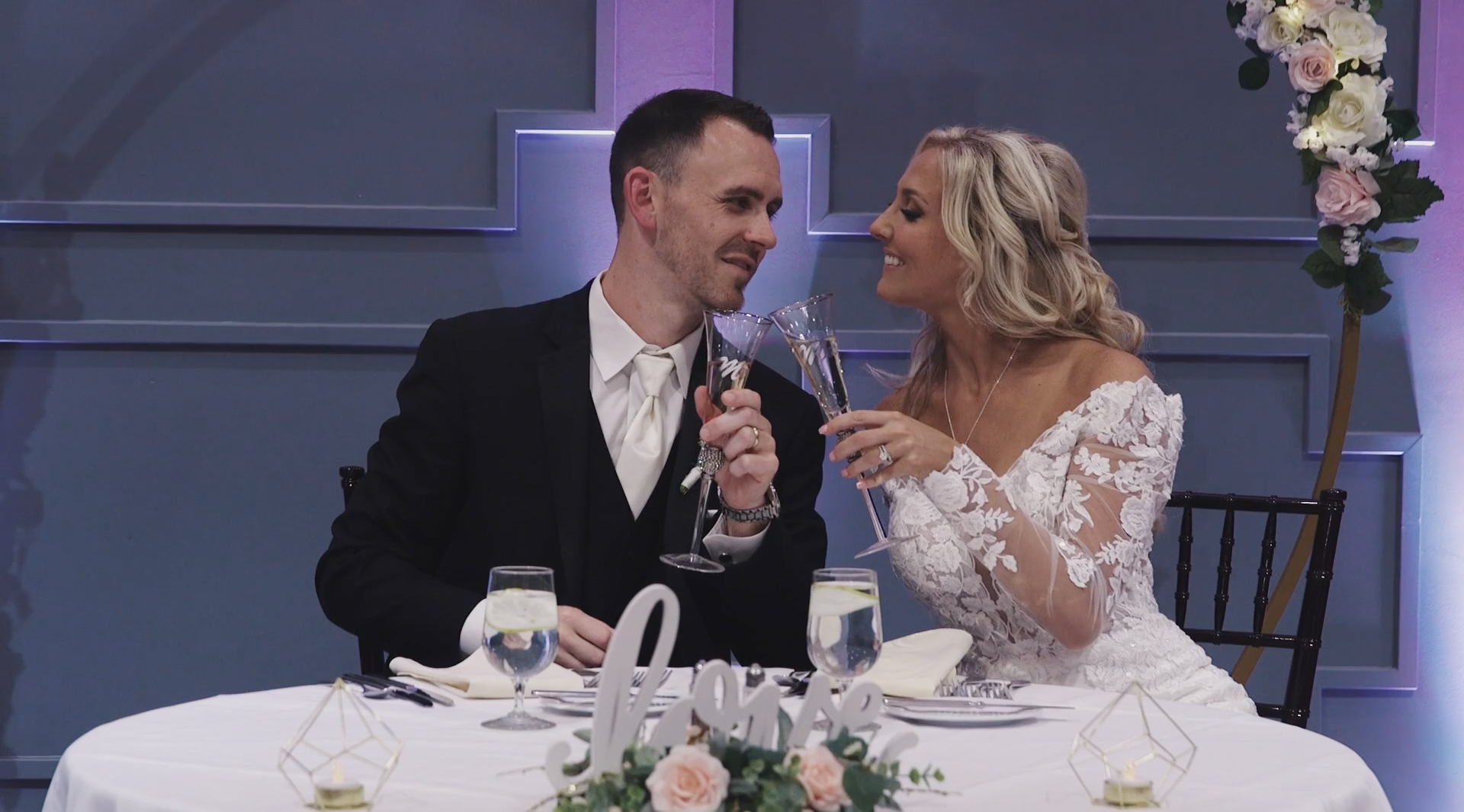 Bride and groom drink champagne.