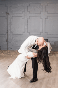 Groom dips the bride on the dancefloor.