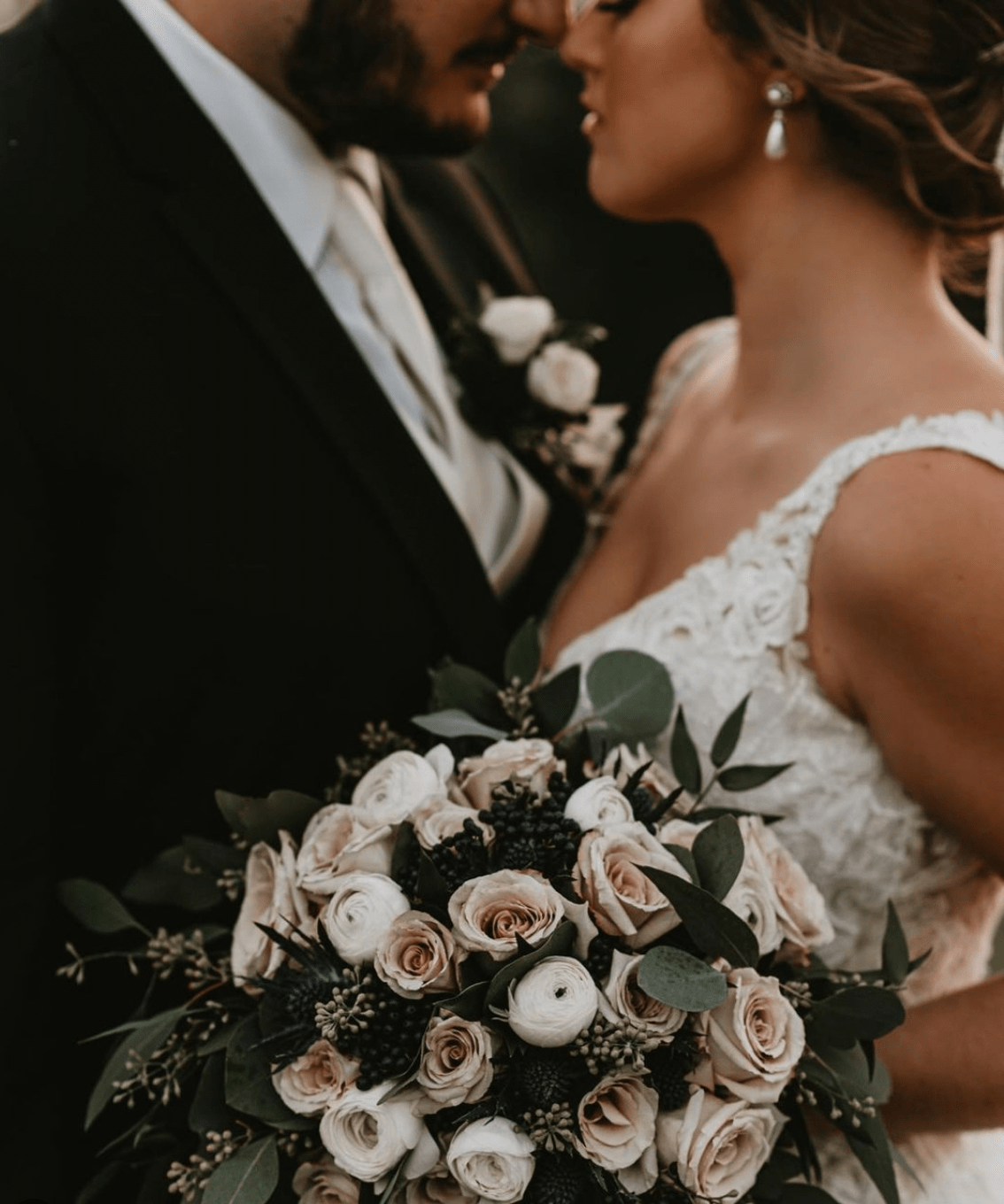 Bride and groom with white bouquet.