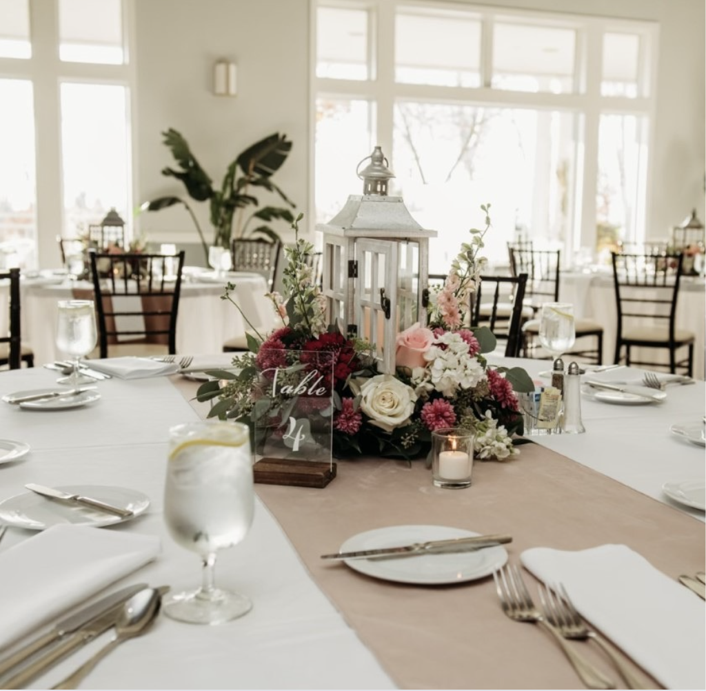 Table setting with flowers and lantern.