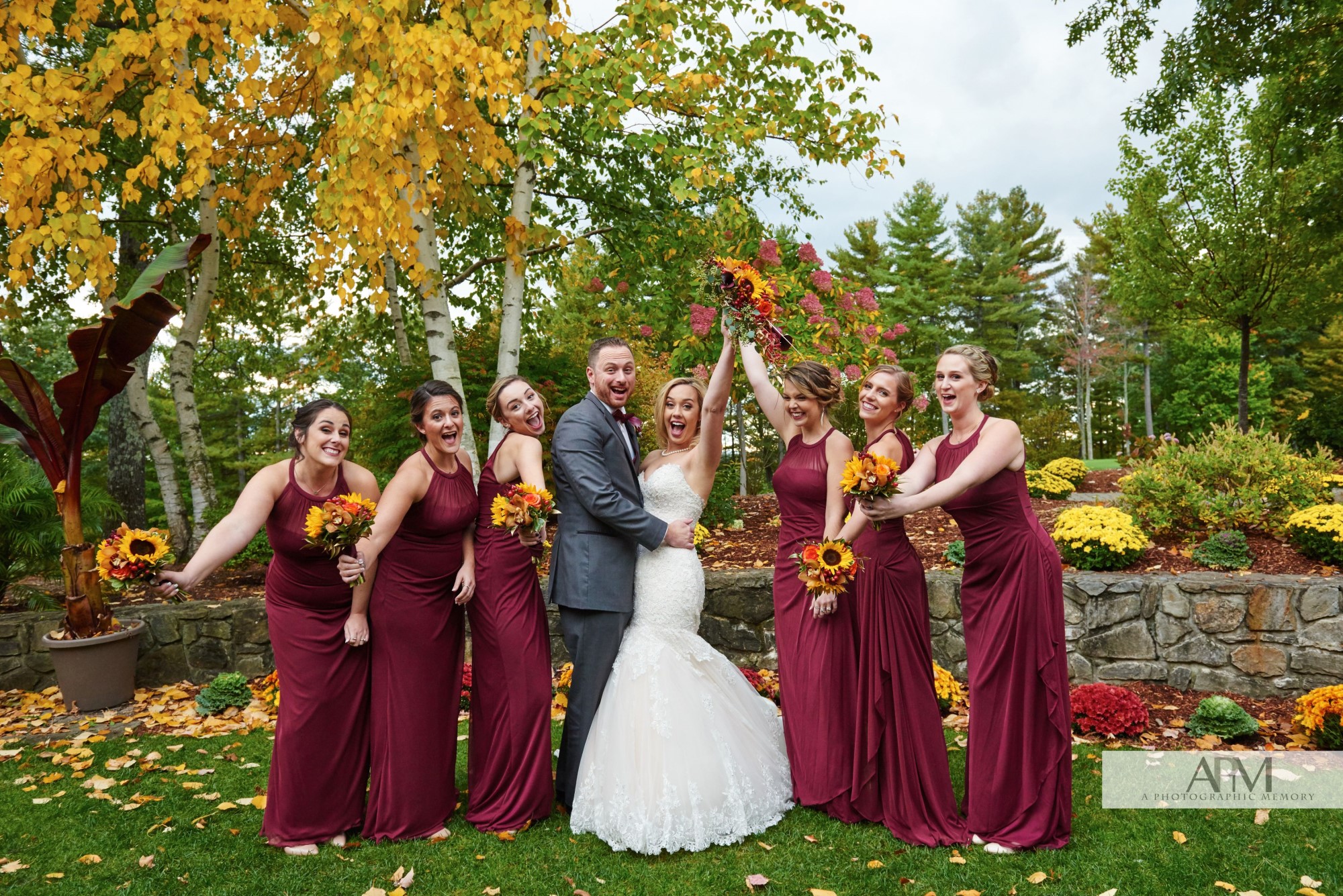 Bride, groom, and bridesmaids among the autumn foliage.