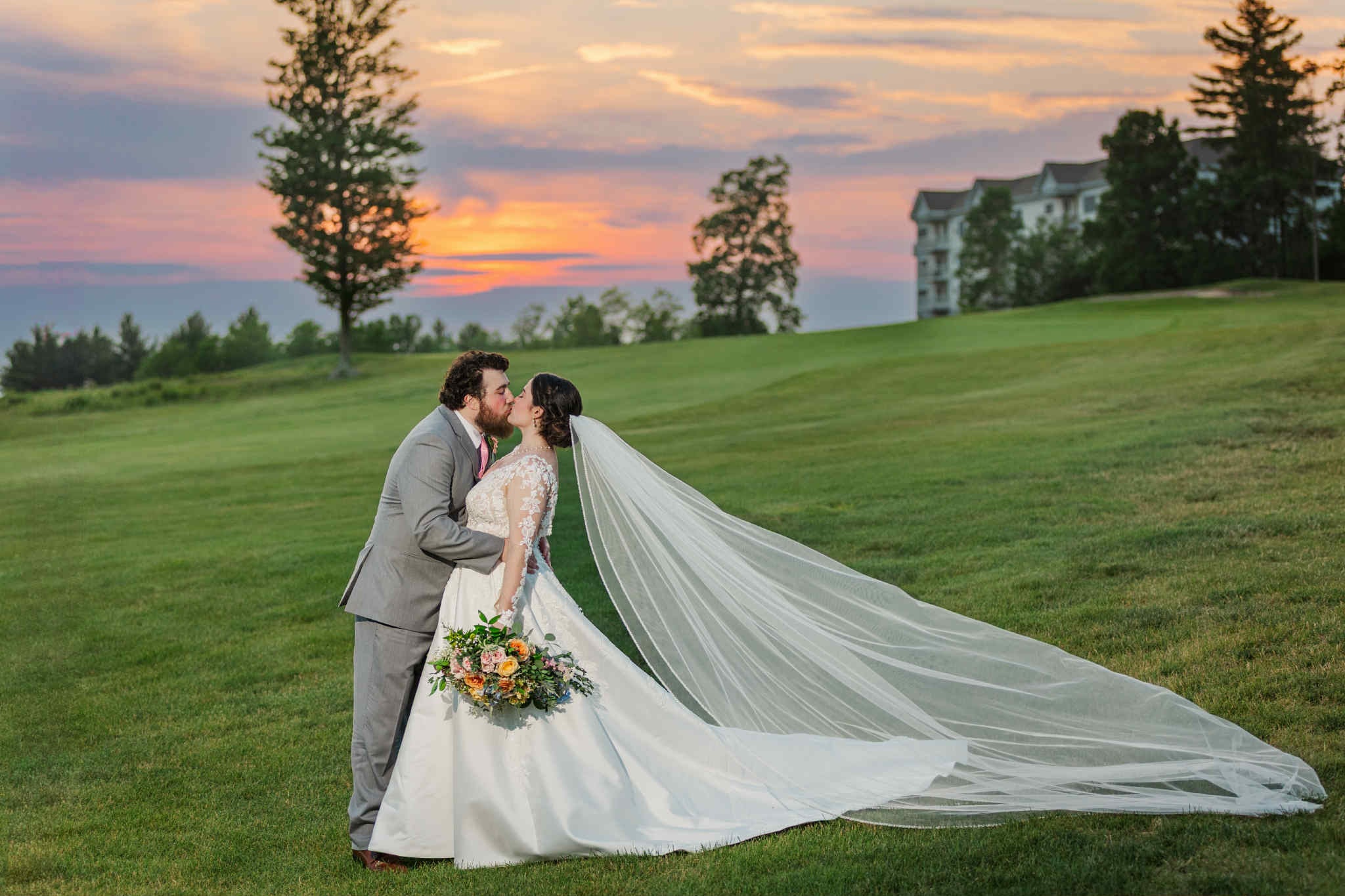 Bride and groom on the course at sunset.