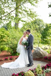 Bride and groom among the foliage.