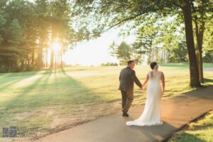 Bride and groom on the course at sunset.