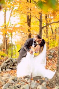 Bride and groom among the foliage.