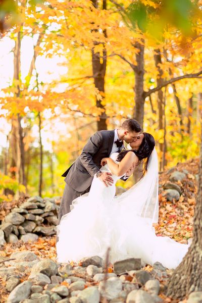 Bride and groom among the foliage.