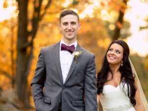 Bride and groom among the foliage.