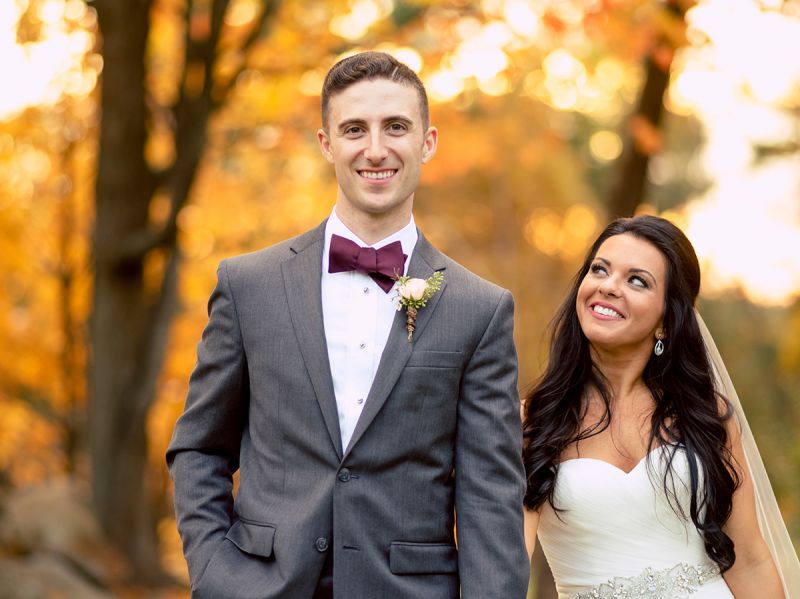 Bride and groom among the foliage.