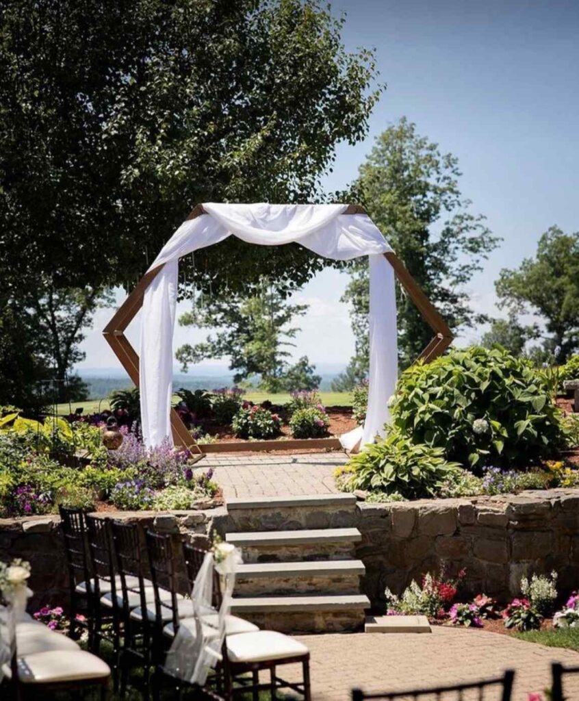 Stone steps lead up to the sun-bathed altar surrounded by flower and landscape features.