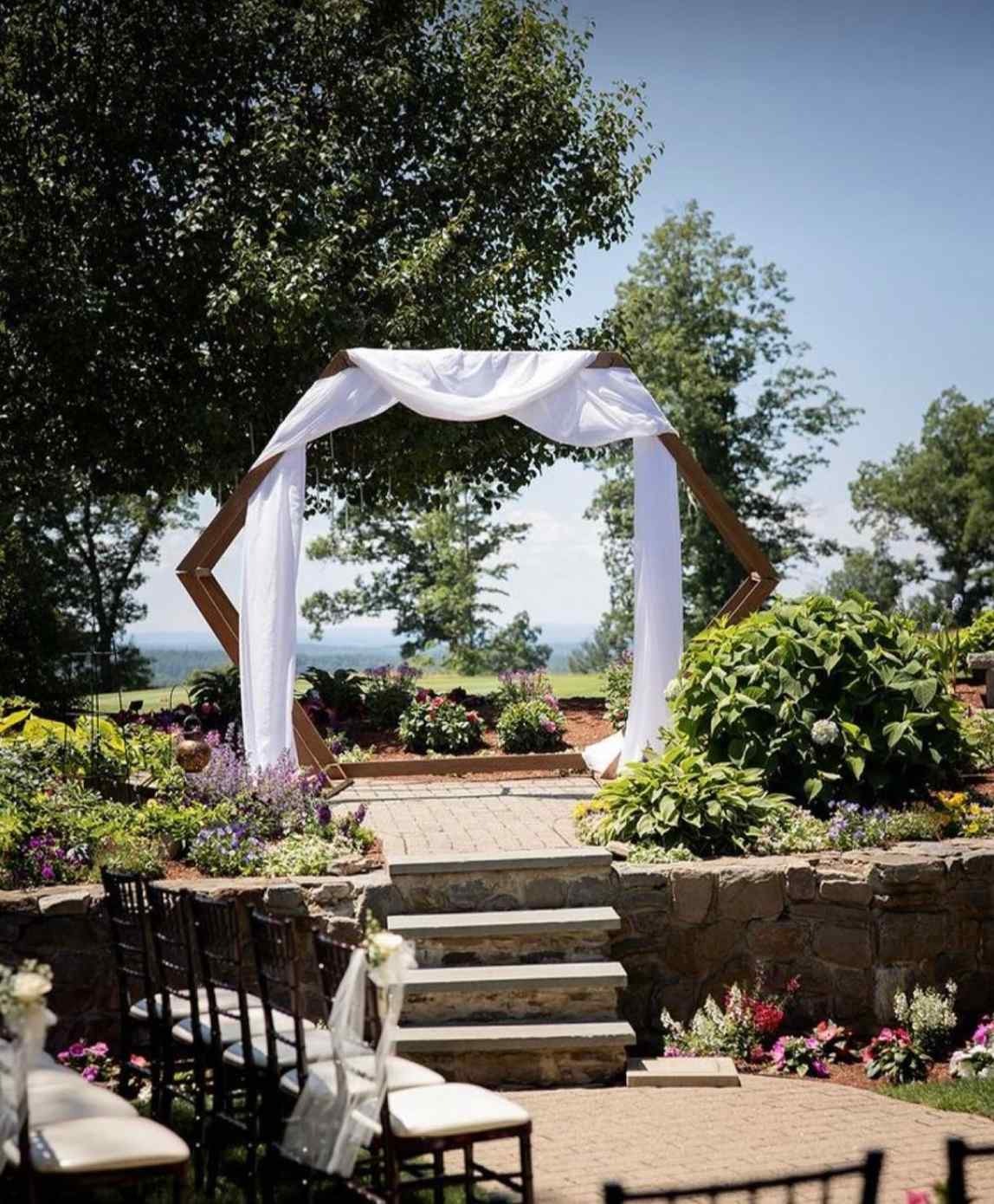 Stone steps lead up to the sun-bathed altar surrounded by flower and landscape features.